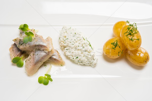 Stock photo: Fish slices with potato on a white plate