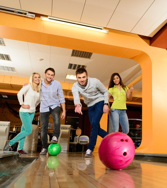 Group of four young smiling people playing bowling  Stock photo © Nejron