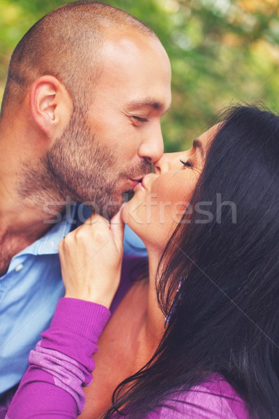 Happy smiling middle-aged couple kissing  outdoors Stock photo © Nejron