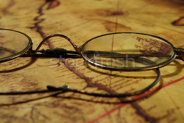 Glasses on the old map Stock photo © Nejron