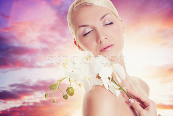 Beautiful woman with orchid flower

 Stock photo © Nejron