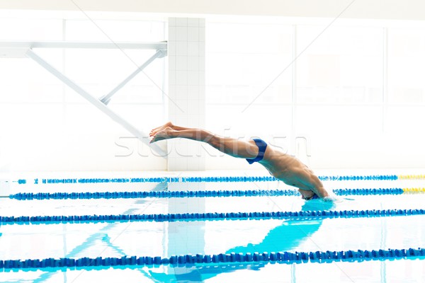 Młodych muskularny pływak skoki basen człowiek Zdjęcia stock © Nejron