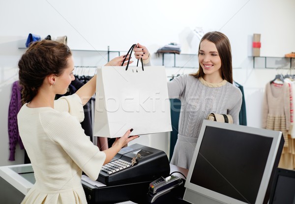 Happy customer with shopping bag in fashion showroom  Stock photo © Nejron