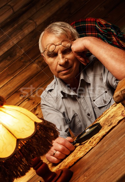Senior man with magnifier fell asleep in homely wooden interior  Stock photo © Nejron