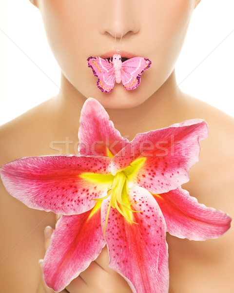Stock photo: Butterfly sitting on a lips of a beautiful woman. Isolated on wh