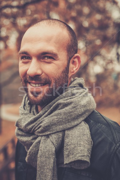 Positive middle-aged man alone on beautiful autumn day Stock photo © Nejron