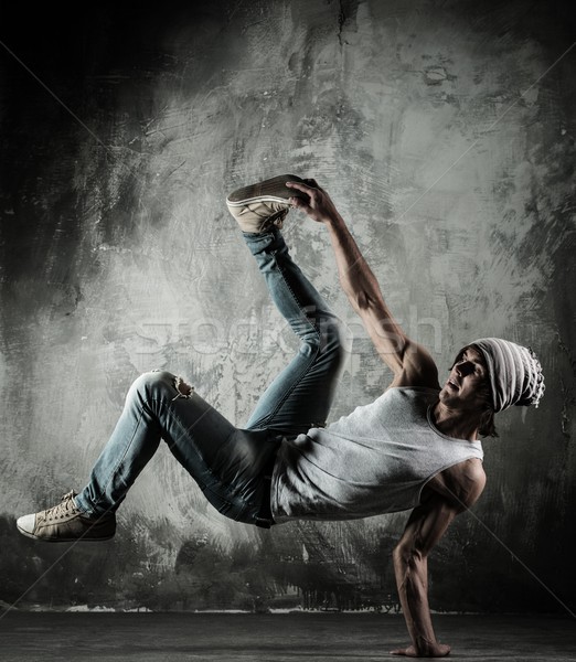 Young b-boy man doing brake dancing movements  Stock photo © Nejron