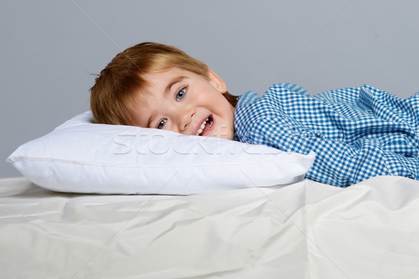 Stock photo: Little boy wearing blue pyjamas in bed