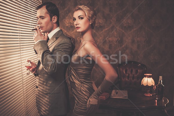 Well-dressed retro style couple near window Stock photo © Nejron