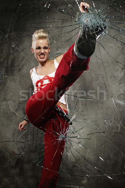 Punk girl breaking glass with her boot Stock photo © Nejron