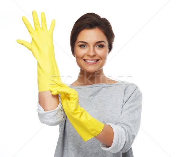 Beautiful cheerful brunette woman pulling on rubber gloves Stock photo © Nejron