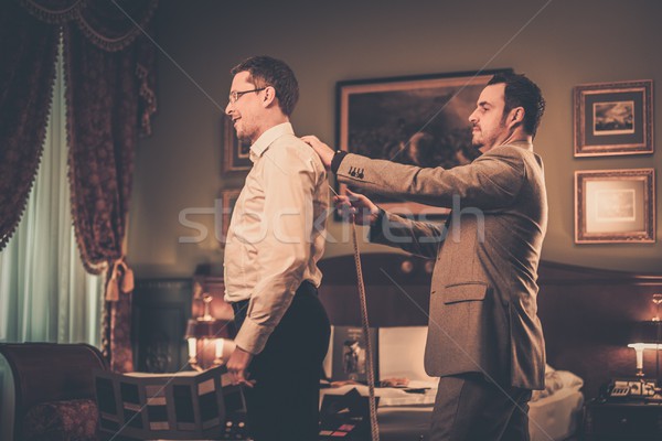 Tailor measuring client for custom made suit tailoring  Stock photo © Nejron