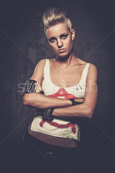 Stock photo: Punk girl with spiked bracelets 