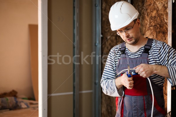 Electrician working with wires in new apartment  Stock photo © Nejron