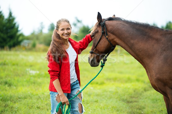 Belo sorridente menina marrom cavalo ao ar livre Foto stock © Nejron