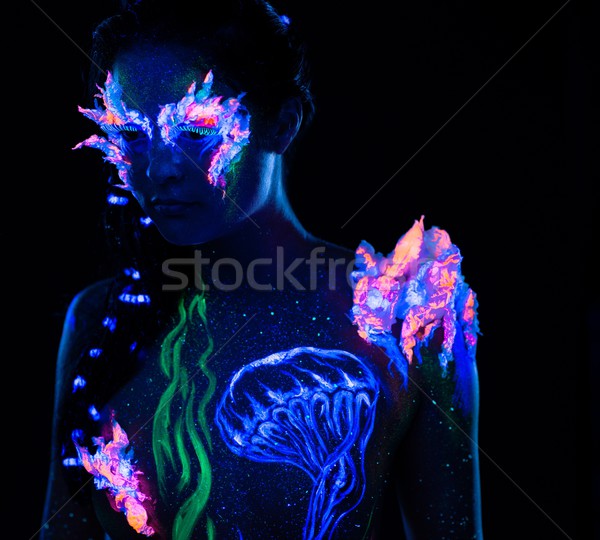 Beautiful woman with body art glowing in ultraviolet light Stock photo © Nejron