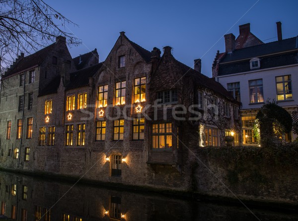House decorated with Christmas stars along canal at night in Bruges, Belgium Stock photo © Nejron