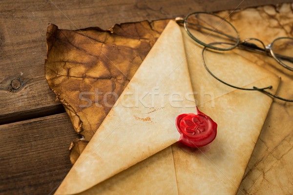 Envelope and glasses on vintage paper over wooden background  Stock photo © Nejron