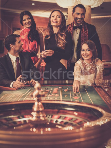 Group of stylish people playing in a casino Stock photo © Nejron