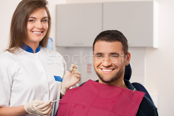 Feliz masculino paciente sorridente feminino dentista Foto stock © Nejron