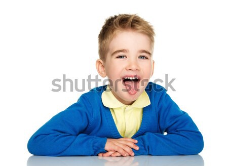 Sly little boy in blue cardigan and yellow shirt showing tongue  Stock photo © Nejron