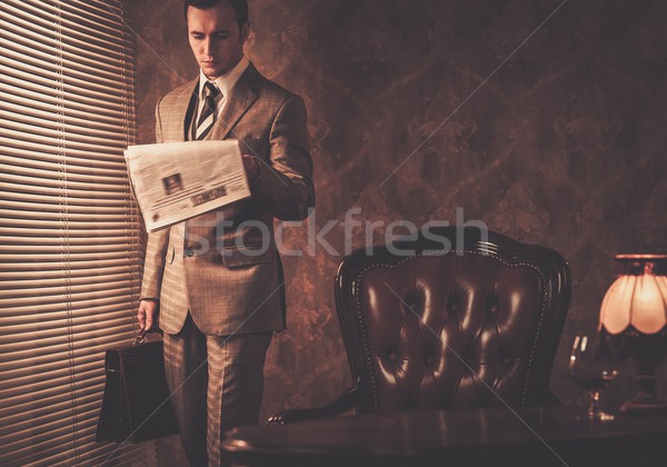 Stock photo: Well-dressed businessman reading newspaper