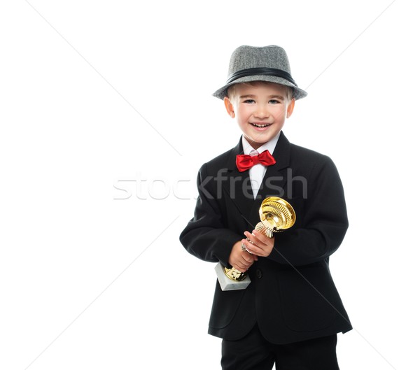 Happy boy in black suit holding prize cup Stock photo © Nejron