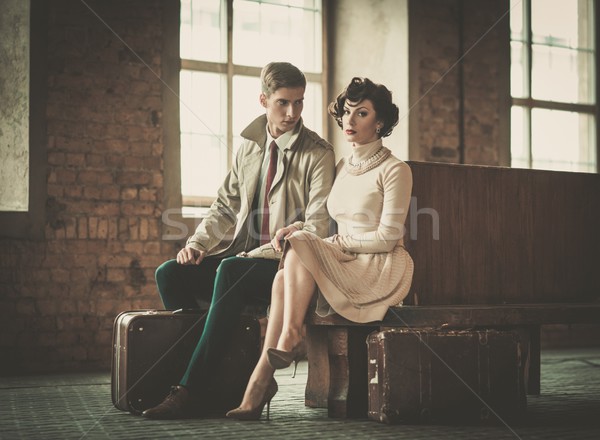 Beautiful vintage style young couple with suitcases on a train station Stock photo © Nejron