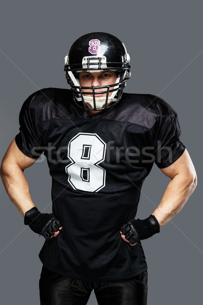 American football player wearing helmet and black jersey with number Stock photo © Nejron