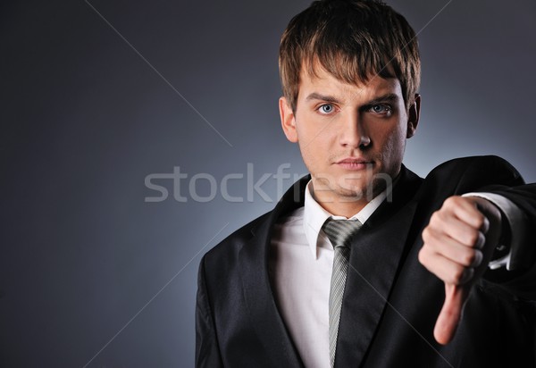 Businessman showing his thumb down Stock photo © Nejron