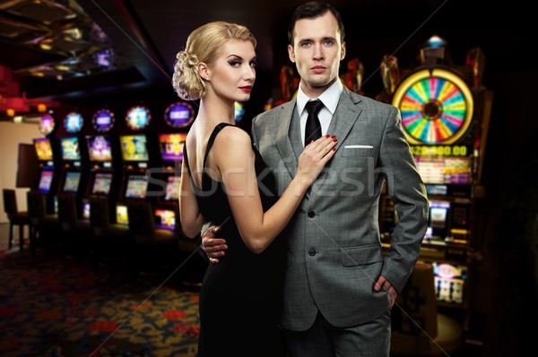 Retro couple against slot machines Stock photo © Nejron