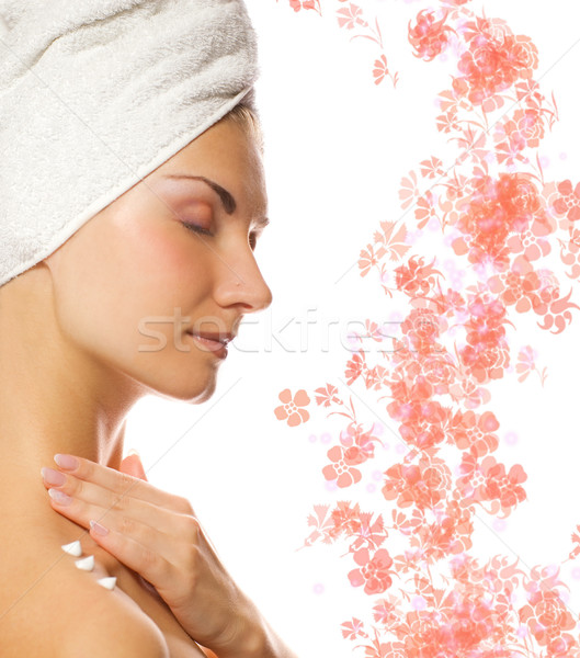 Young lovely lady applying moisturizer to her skin after shower  Stock photo © Nejron