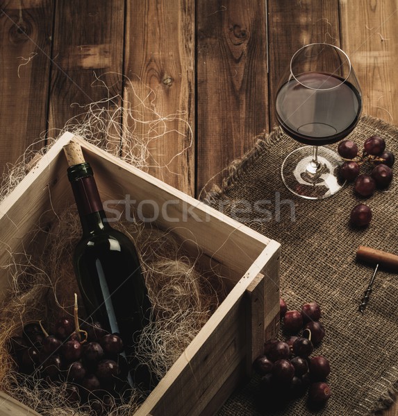 Bottle, glass and red grape on a wooden table  Stock photo © Nejron