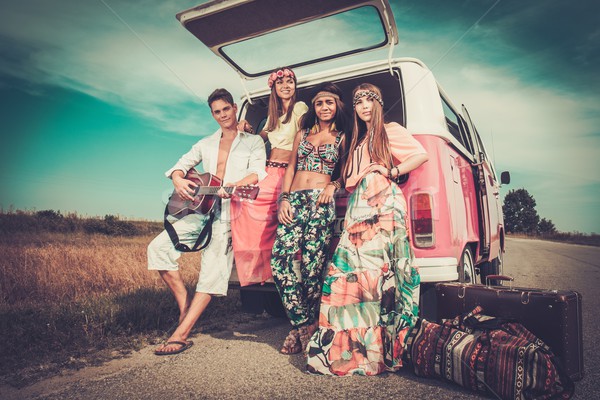 Multi-ethnic hippie friends with guitar on a road trip Stock photo © Nejron
