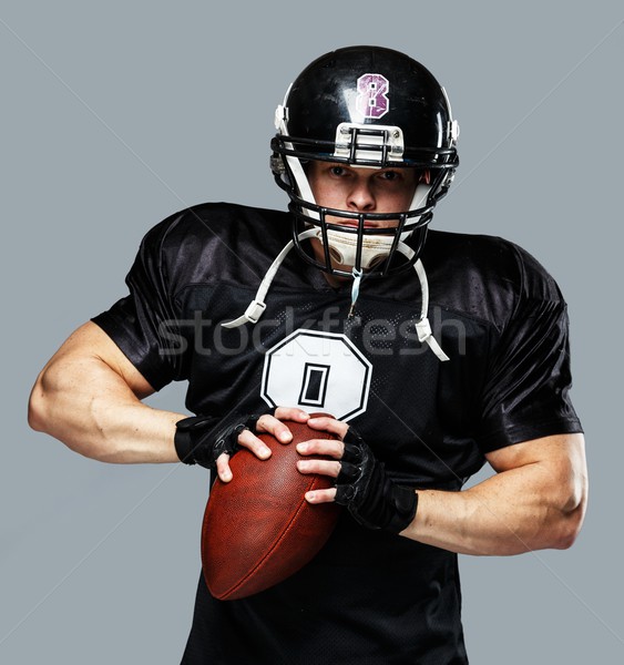 American football player with ball wearing helmet and jersey  Stock photo © Nejron