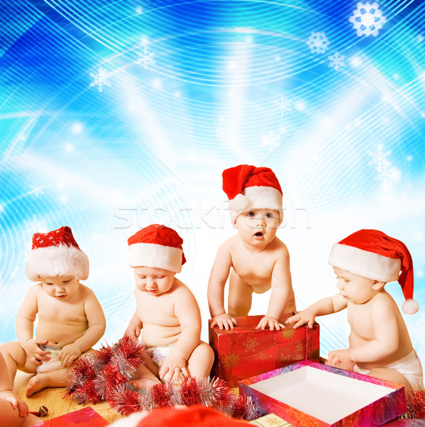 Group of adorable toddlers in Christmas hats packing presents Stock photo © Nejron