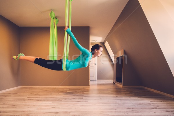 Young woman performing antigravity yoga exercise  Stock photo © Nejron