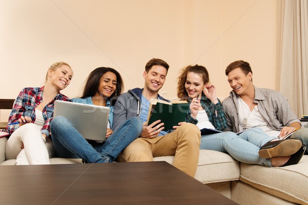 Group of multi ethnic young students preparing for exams in home interior  Stock photo © Nejron