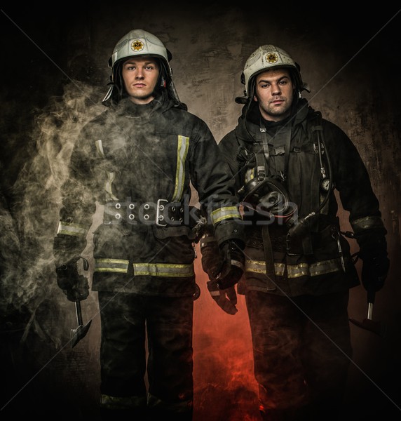 Two firefighters with helmet and axe in a smoke Stock photo © Nejron