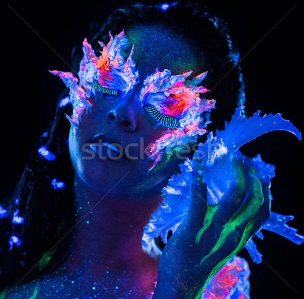 Portrait of beautiful woman with body art glowing in ultraviolet light Stock photo © Nejron