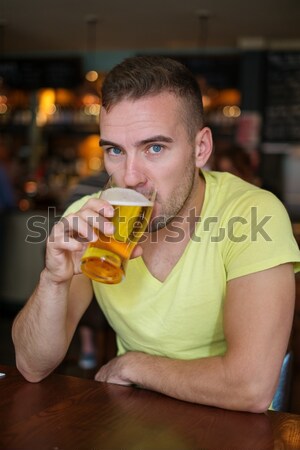 Jóképű fiatalember világos sör kocsma asztal bár Stock fotó © Nejron
