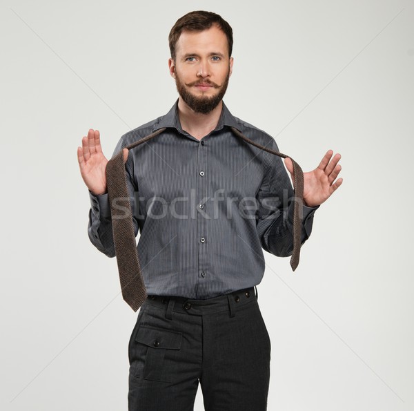Handsome man with beard tying a tie Stock photo © Nejron
