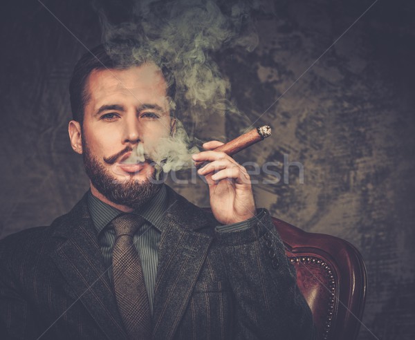 Handsome well-dressed with glass of beverage and cigar Stock photo © Nejron