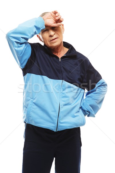 Stock photo: Senior man in training suit feeling headache migraines 