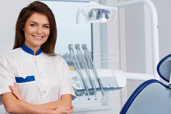 Young beautiful brunette female dentist at dentist's surgery  Stock photo © Nejron