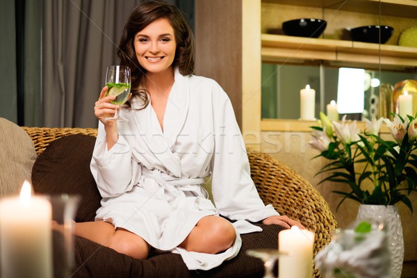 Beautiful woman relaxing in a bathrobe in spa salon  Stock photo © Nejron