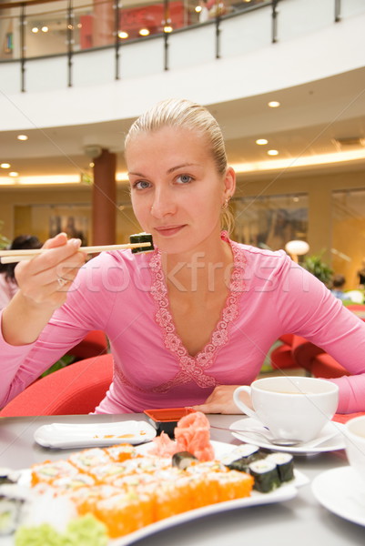Girl eats sushi in a reastaurant Stock photo © Nejron