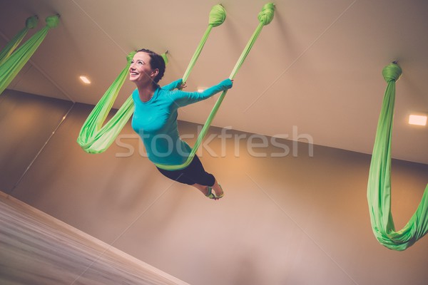 Young woman performing antigravity yoga exercise  Stock photo © Nejron