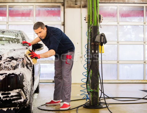 Man worker washing luxury car with sponge on a car wash  Stock photo © Nejron
