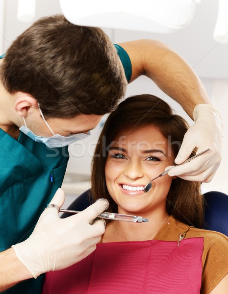 Stock photo: Dentist making anaesthetic injection to woman patient 
